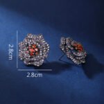 Wholesale floral zircon earrings with white pavé petals on real gold plated copper from JuneJewelry.com – luxury blossom studs for bulk orders.