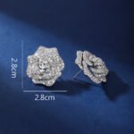 Wholesale floral zircon earrings with white pavé petals on real gold plated copper from JuneJewelry.com – luxury blossom studs for bulk orders.