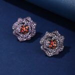 Wholesale floral zircon earrings with white pavé petals on real gold plated copper from JuneJewelry.com – luxury blossom studs for bulk orders.