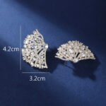 Wholesale pink flower earrings with central yellow zircon and 925 silver needles from JuneJewelry.com – unique floral brass jewelry for bulk buyers.