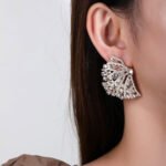 Wholesale pink flower earrings with central yellow zircon and 925 silver needles from JuneJewelry.com – unique floral brass jewelry for bulk buyers.