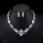 Wholesale oval zircon set with crisscross link necklace and 925 silver needle earrings from JuneJewelry.com – luxury gold plated bridal jewelry.