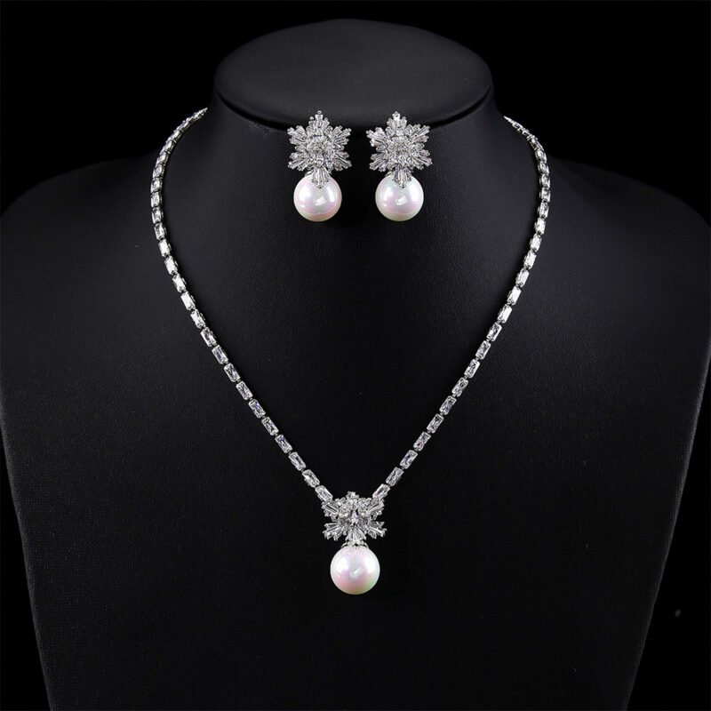 Wholesale snowflake jewelry set with shell pearls and zircon stones on 18K gold plated copper from JuneJewelry.com – luxury 925 silver needle bridal jewelry.
