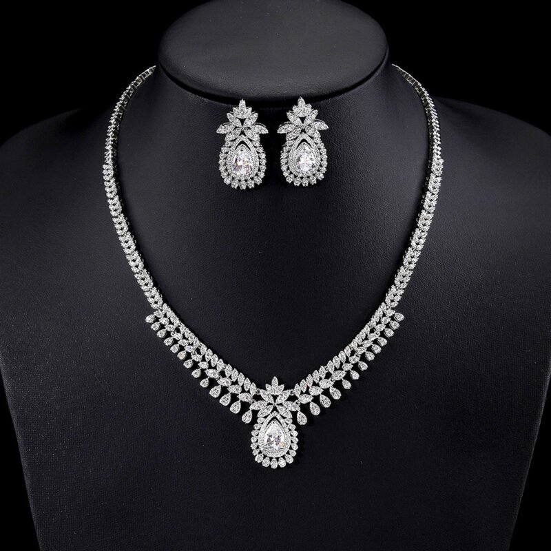 Wholesale copper zircon set featuring a luxury teardrop pendant and matching earrings in 18K gold plating from JuneJewelry.com.