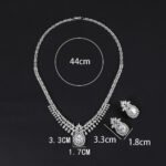 Wholesale copper zircon set featuring a luxury teardrop pendant and matching earrings in 18K gold plating from JuneJewelry.com.