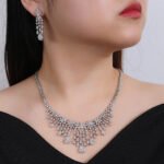 Wholesale platinum zircon set featuring a teardrop pendant and matching earrings in silver-tone copper from JuneJewelry.com – luxury wedding jewelry for bulk orders.