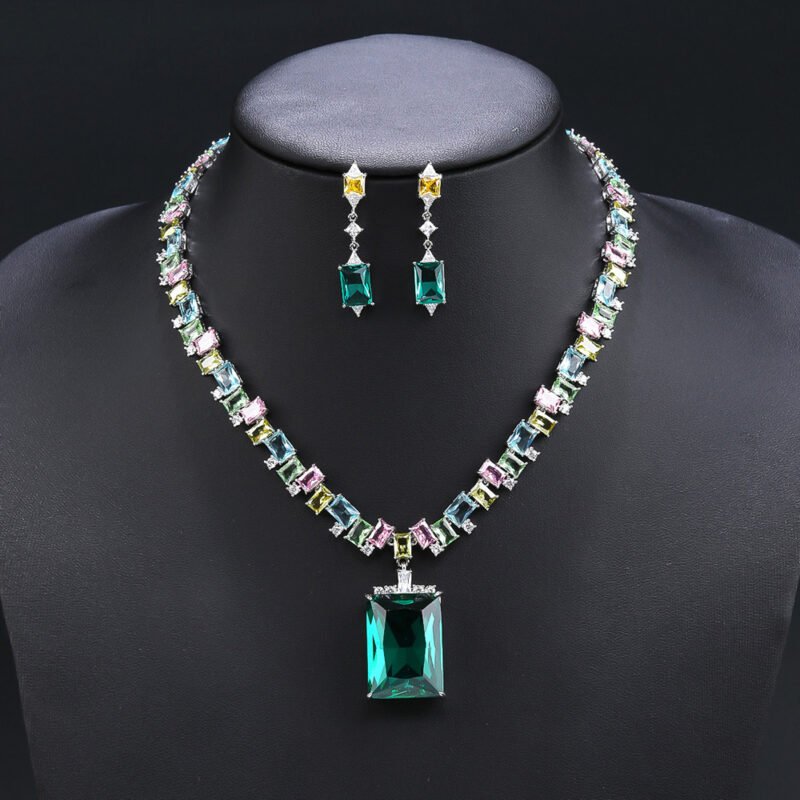 Wholesale emerald zircon set with large radiant center stone and gold plated copper from JuneJewelry.com – high-quality 925 silver needle jewelry.