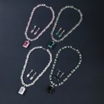 Wholesale emerald zircon set with large radiant center stone and gold plated copper from JuneJewelry.com – high-quality 925 silver needle jewelry.