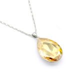 Elegant teardrop-shaped Swarovski element crystal pendant necklace with white gold plating, available for fashion jewelry wholesale at junejewelry.com.