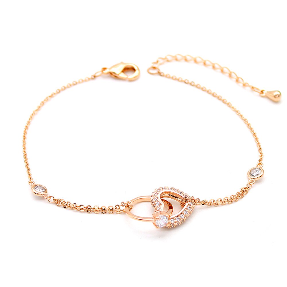 Wholesale copper zircon bracelet with 18K gold plating and shimmering heart charms from JuneJewelry.com – luxury fashion jewelry for bulk orders.