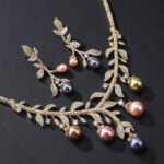 Wholesale pearl zircon set featuring a leaf-inspired necklace and earrings with colorful shell pearls and real gold plated copper from JuneJewelry.com.