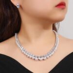 Wholesale teardrop pearl set with pear-cut zircons and white shell pearls on gold plated copper from JuneJewelry.com – bridal jewelry for bulk orders.