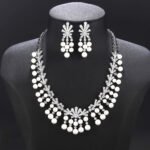 Wholesale fan pearl set featuring a sunburst necklace and earrings with white shell pearls and gold plated copper from JuneJewelry.com.