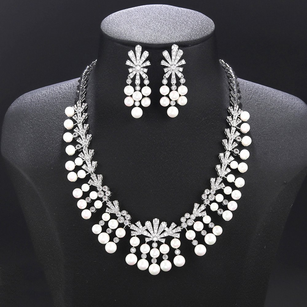 Wholesale fan pearl set featuring a sunburst necklace and earrings with white shell pearls and gold plated copper from JuneJewelry.com.