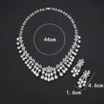 Wholesale fan pearl set featuring a sunburst necklace and earrings with white shell pearls and gold plated copper from JuneJewelry.com.