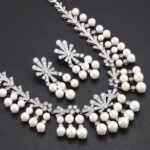 Wholesale fan pearl set featuring a sunburst necklace and earrings with white shell pearls and gold plated copper from JuneJewelry.com.