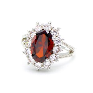 Wholesale luxury zircon ring featuring a large red oval stone on gold plated copper from JuneJewelry.com – adjustable high-quality jewelry for bulk buyers.