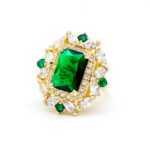 Wholesale emerald cut ring with a large red zircon and 18K gold plated copper band from JuneJewelry.com – adjustable luxury jewelry for bulk orders.