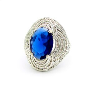 Wholesale blue zircon ring with oval-cut center stone and tiered halo design on gold plated copper from JuneJewelry.com – adjustable cocktail jewelry for bulk orders.