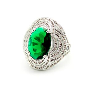 Wholesale blue zircon ring with oval-cut center stone and tiered halo design on gold plated copper from JuneJewelry.com – adjustable cocktail jewelry for bulk orders.