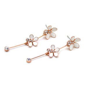 Wholesale daisy drop earrings with white enamel petals and crystal centers on rose gold plated alloy from JuneJewelry.com – floral bulk jewelry.