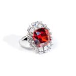 Wholesale red zircon ring with a large cushion-cut stone and white gold plated copper band from JuneJewelry.com – adjustable luxury jewelry for bulk buyers.