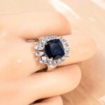 Wholesale red zircon ring with a large cushion-cut stone and white gold plated copper band from JuneJewelry.com – adjustable luxury jewelry for bulk buyers.