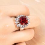 Wholesale red zircon ring with a large cushion-cut stone and white gold plated copper band from JuneJewelry.com – adjustable luxury jewelry for bulk buyers.