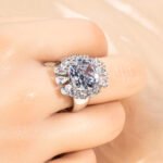 Wholesale red zircon ring with a large cushion-cut stone and white gold plated copper band from JuneJewelry.com – adjustable luxury jewelry for bulk buyers.