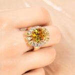 Wholesale red zircon ring with a large cushion-cut stone and white gold plated copper band from JuneJewelry.com – adjustable luxury jewelry for bulk buyers.