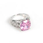 Wholesale pink zircon ring with a large cushion-cut stone on platinum plated copper from JuneJewelry.com – adjustable feminine jewelry for bulk orders.