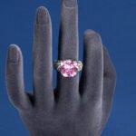 Wholesale pink zircon ring with a large cushion-cut stone on platinum plated copper from JuneJewelry.com – adjustable feminine jewelry for bulk orders.