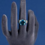 Wholesale pink zircon ring with a large cushion-cut stone on platinum plated copper from JuneJewelry.com – adjustable feminine jewelry for bulk orders.