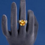 Wholesale pink zircon ring with a large cushion-cut stone on platinum plated copper from JuneJewelry.com – adjustable feminine jewelry for bulk orders.