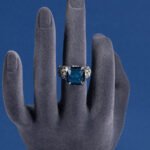 Wholesale pink zircon ring with a large cushion-cut stone on platinum plated copper from JuneJewelry.com – adjustable feminine jewelry for bulk orders.