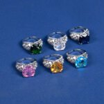 Wholesale pink zircon ring with a large cushion-cut stone on platinum plated copper from JuneJewelry.com – adjustable feminine jewelry for bulk orders.