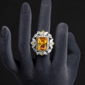 Wholesale emerald cut ring with a large red zircon and 18K gold plated copper band from JuneJewelry.com – adjustable luxury jewelry for bulk orders.