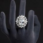 Wholesale emerald cut ring with a large red zircon and 18K gold plated copper band from JuneJewelry.com – adjustable luxury jewelry for bulk orders.