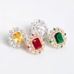 Wholesale emerald cut ring with a large red zircon and 18K gold plated copper band from JuneJewelry.com – adjustable luxury jewelry for bulk orders.