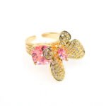 Wholesale butterfly open ring with pink zircon stones and real gold plating on copper from JuneJewelry.com – adjustable fashion ring for bulk orders.