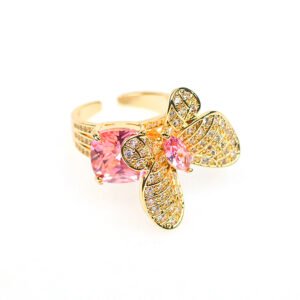 Wholesale butterfly open ring with pink zircon stones and real gold plating on copper from JuneJewelry.com – adjustable fashion ring for bulk orders.
