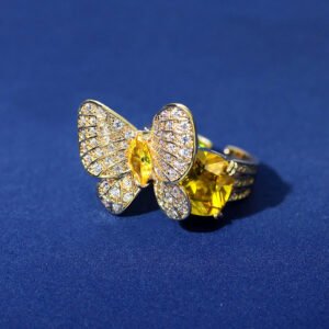 Wholesale butterfly open ring with pink zircon stones and real gold plating on copper from JuneJewelry.com – adjustable fashion ring for bulk orders.