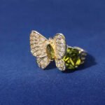 Wholesale butterfly open ring with pink zircon stones and real gold plating on copper from JuneJewelry.com – adjustable fashion ring for bulk orders.