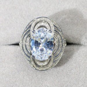 Wholesale blue zircon ring with oval-cut center stone and tiered halo design on gold plated copper from JuneJewelry.com – adjustable cocktail jewelry for bulk orders.