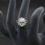 Wholesale luxury zircon ring featuring a large red oval stone on gold plated copper from JuneJewelry.com – adjustable high-quality jewelry for bulk buyers.