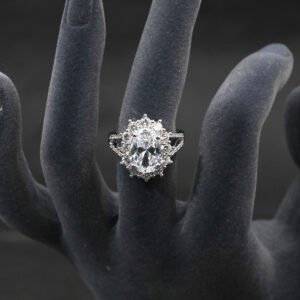 Wholesale luxury zircon ring featuring a large red oval stone on gold plated copper from JuneJewelry.com – adjustable high-quality jewelry for bulk buyers.