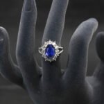 Wholesale luxury zircon ring featuring a large red oval stone on gold plated copper from JuneJewelry.com – adjustable high-quality jewelry for bulk buyers.