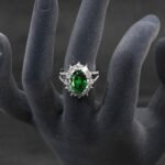 Wholesale luxury zircon ring featuring a large red oval stone on gold plated copper from JuneJewelry.com – adjustable high-quality jewelry for bulk buyers.