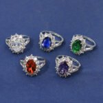 Wholesale luxury zircon ring featuring a large red oval stone on gold plated copper from JuneJewelry.com – adjustable high-quality jewelry for bulk buyers.