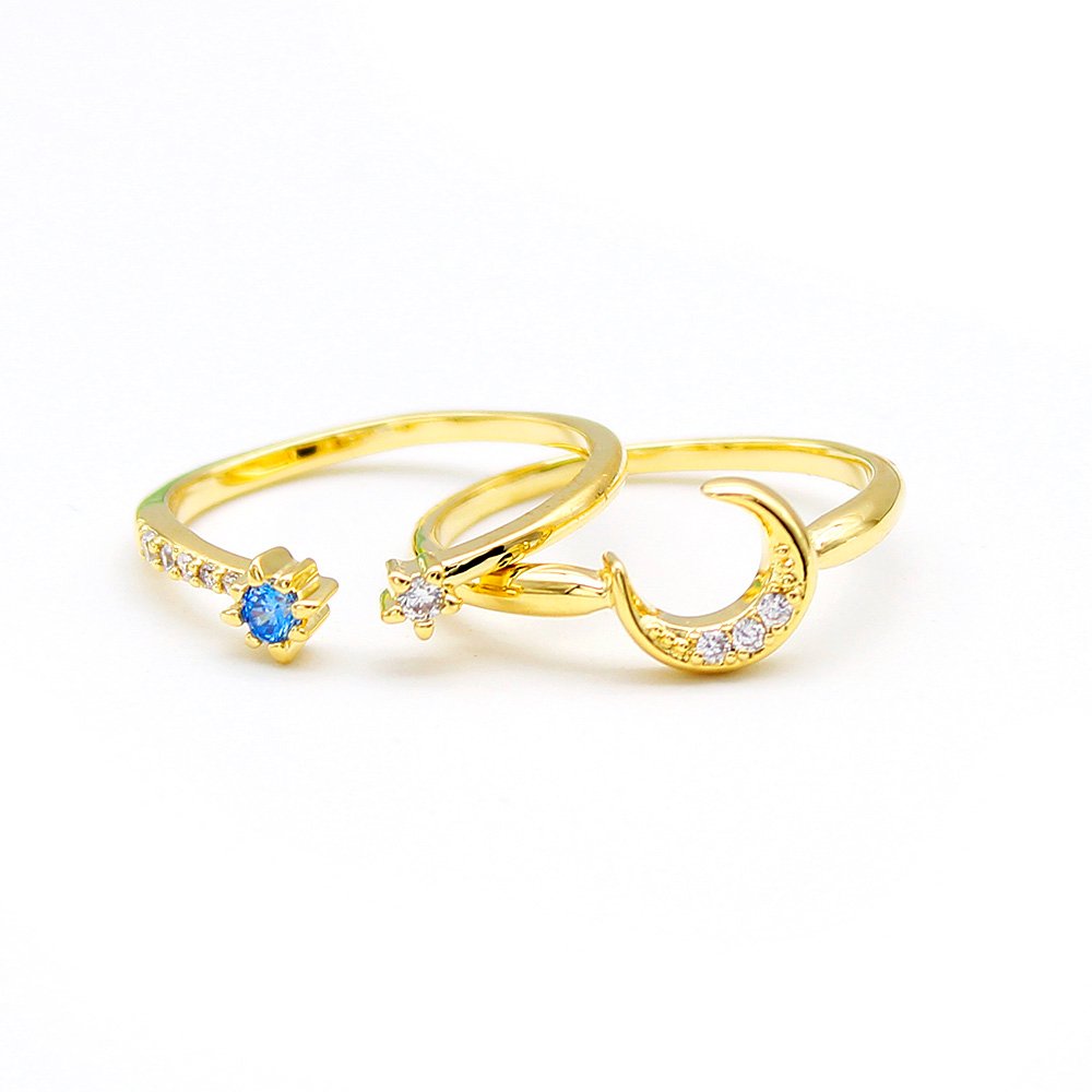 Wholesale moon star ring set with blue and white zircons on 18K gold plated copper from JuneJewelry.com – adjustable celestial jewelry for bulk orders.